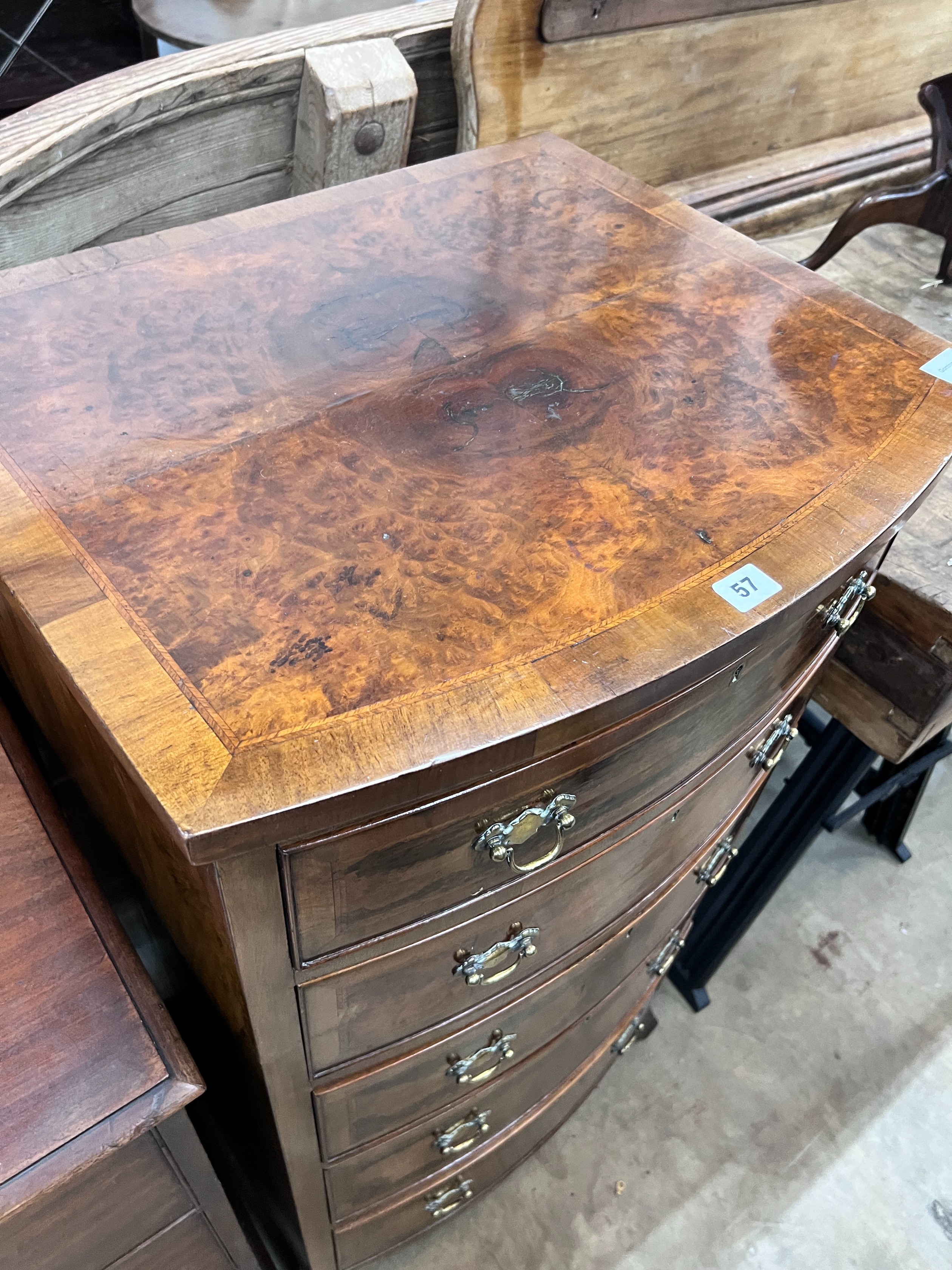 A Queen Anne revival feather banded walnut bowfront five drawer chest, width 61cm, depth 52cm, height 116cm *Please note the sale commences at 9am.